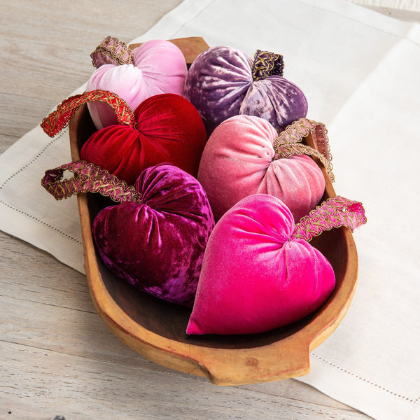 Handmade velvet hearts available in 12 colors and prints.  Photo shows 6 velvet hearts in a wooden dough bowl on a table.